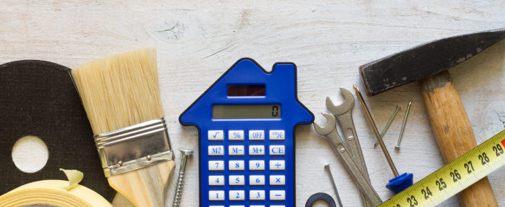 Tools to fix and flip a house next to a calculator