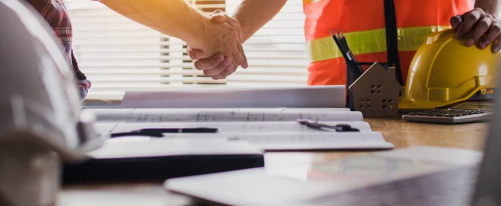 Construction manager and real estate developer shaking hands