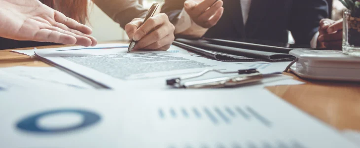 Real estate investors drawing up graphs to understand challenges in real estate market