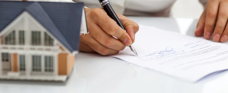 Real estate lender signing papers